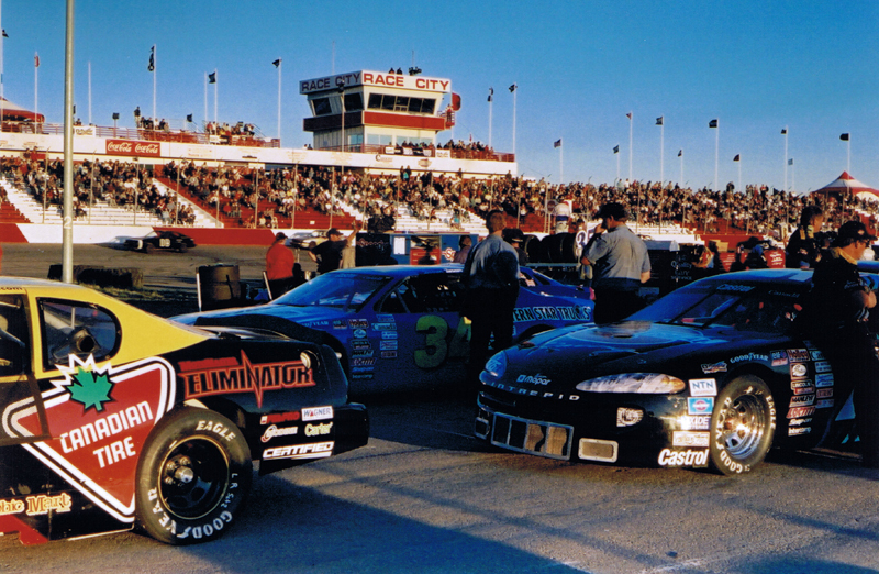 Darren Turner's race car sits beside Al Turner's Blue Streak Intrepid & Pete Gibbons Canadian Tire Monte Carlo